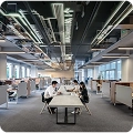 Entrepreneurs discussing company registration in Dubai at a shared office space.