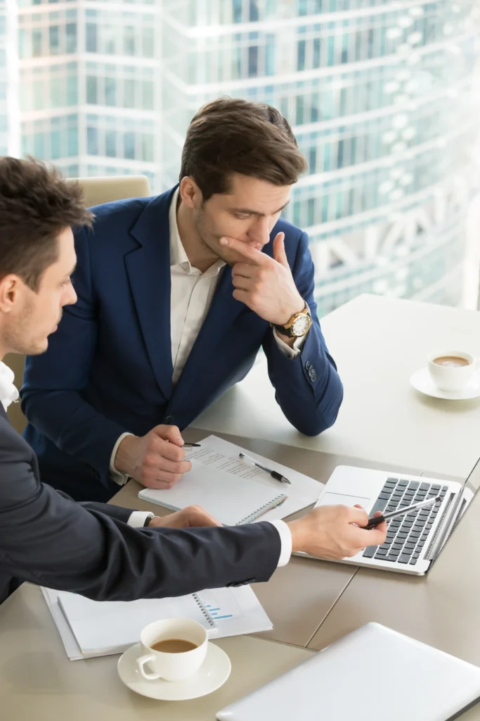Business consultants discussing mainland company formation options in Dubai office